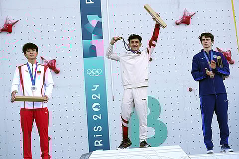 Men's speed final: Gold medallist Veddriq Leonardo of Indonesia, center, silver medallist Wu Peng of China, left, and bronze medallist Sam Watson of the United States